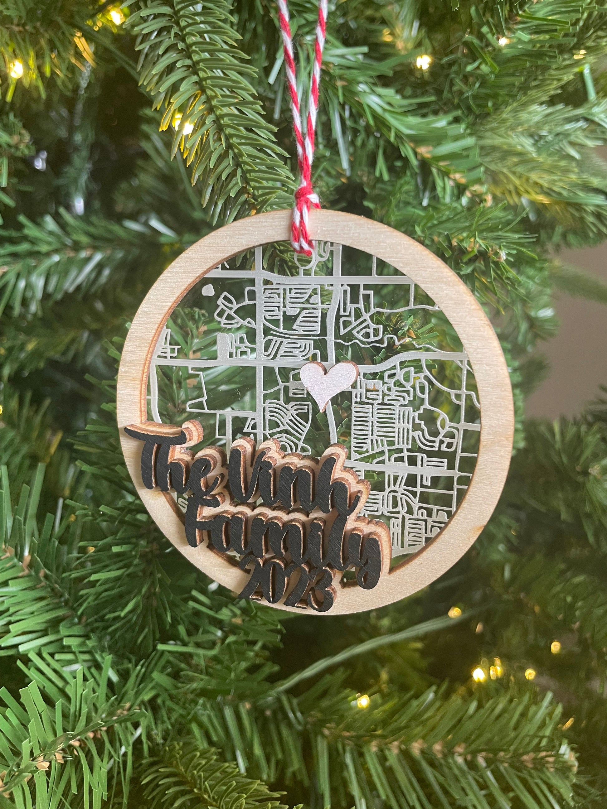 acrylic and wood map ornament on green Christmas tree